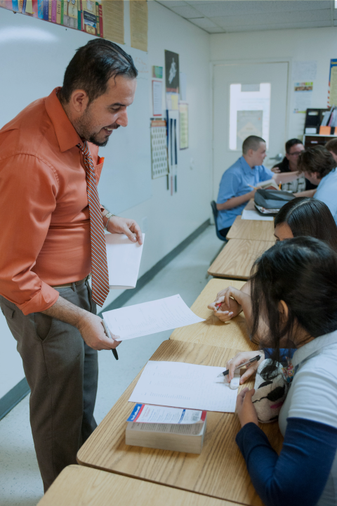 A teacher encouraging a student in the classroom
